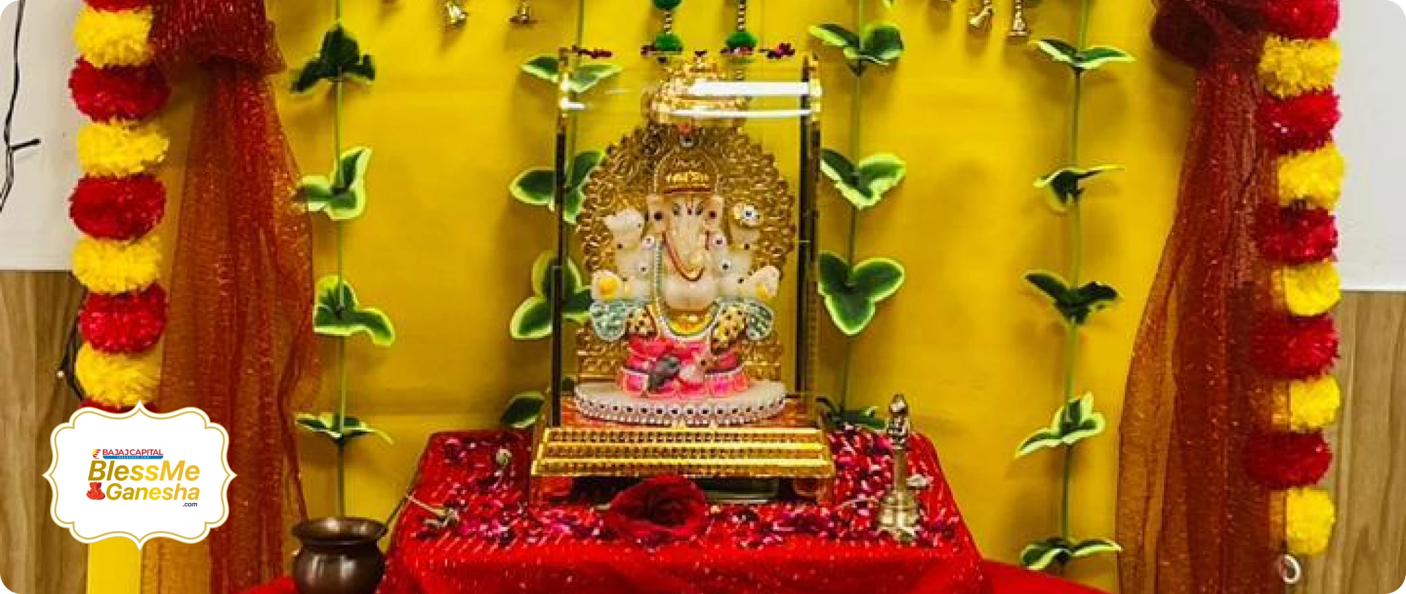 Ganesha in a yellow and red floral setting