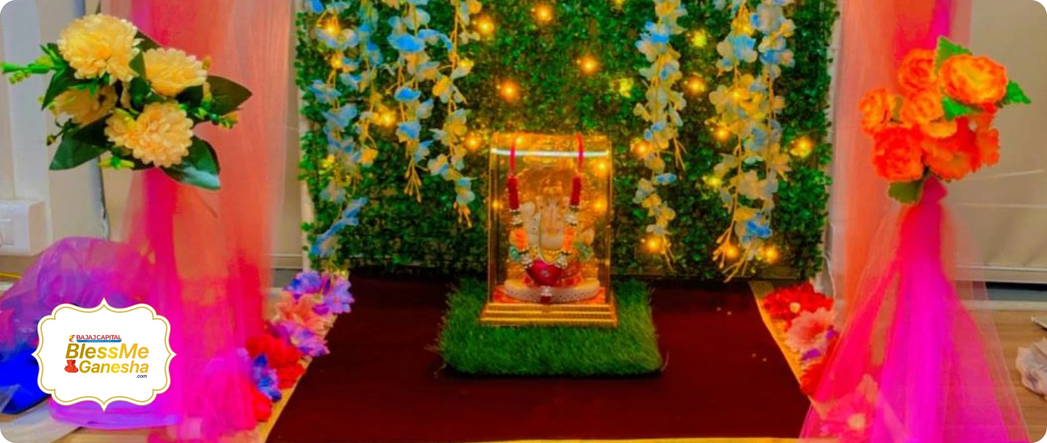 A floral Ganesha installation illuminated for aarti
